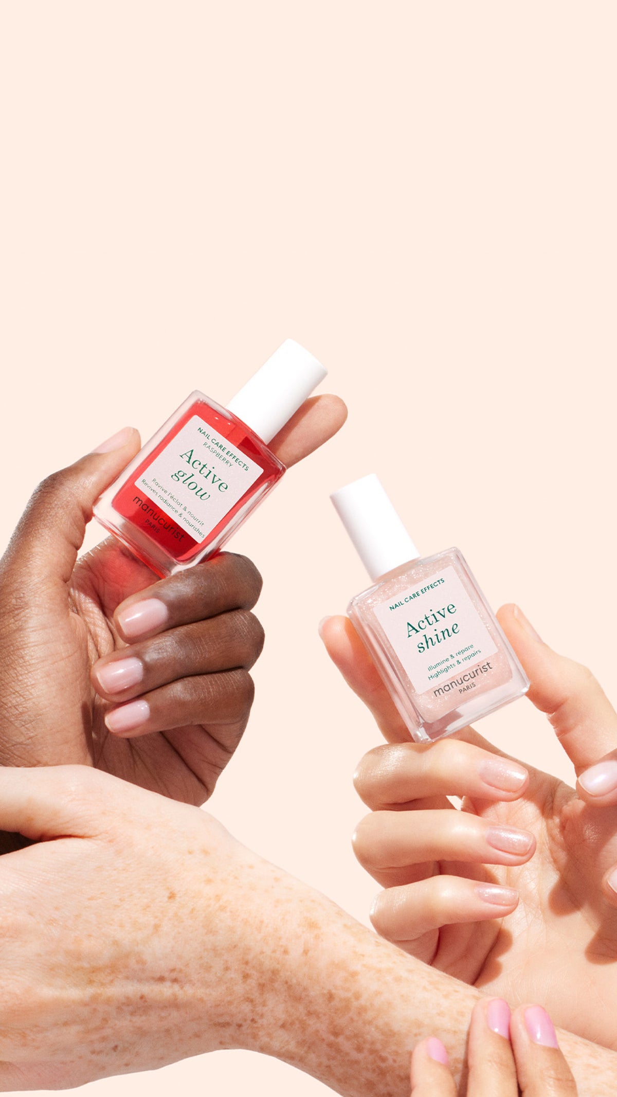 Two hands hold nail polish bottles—one red labeled Active Glow and one clear labeled Active Shine—against a light peach background, with other hands gently touching below.