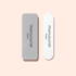 Two Mini Nail File Duo buffers by Manucurist-test are side by side on a pale pink background: the left is gray and rectangular, while the right is white with rounded ends.