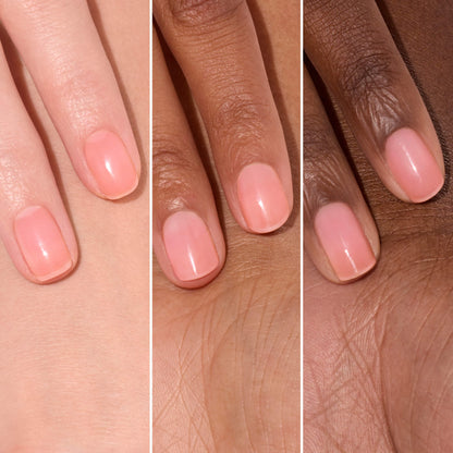 Three hands with different skin tones display neatly manicured, short nails painted with Manucurist’s Active™ Glow Cranberry—a sheer, light pink polish—showcasing the beauty of plant-based nail care. The glossy and smooth finish highlights the product’s natural, healthy look.