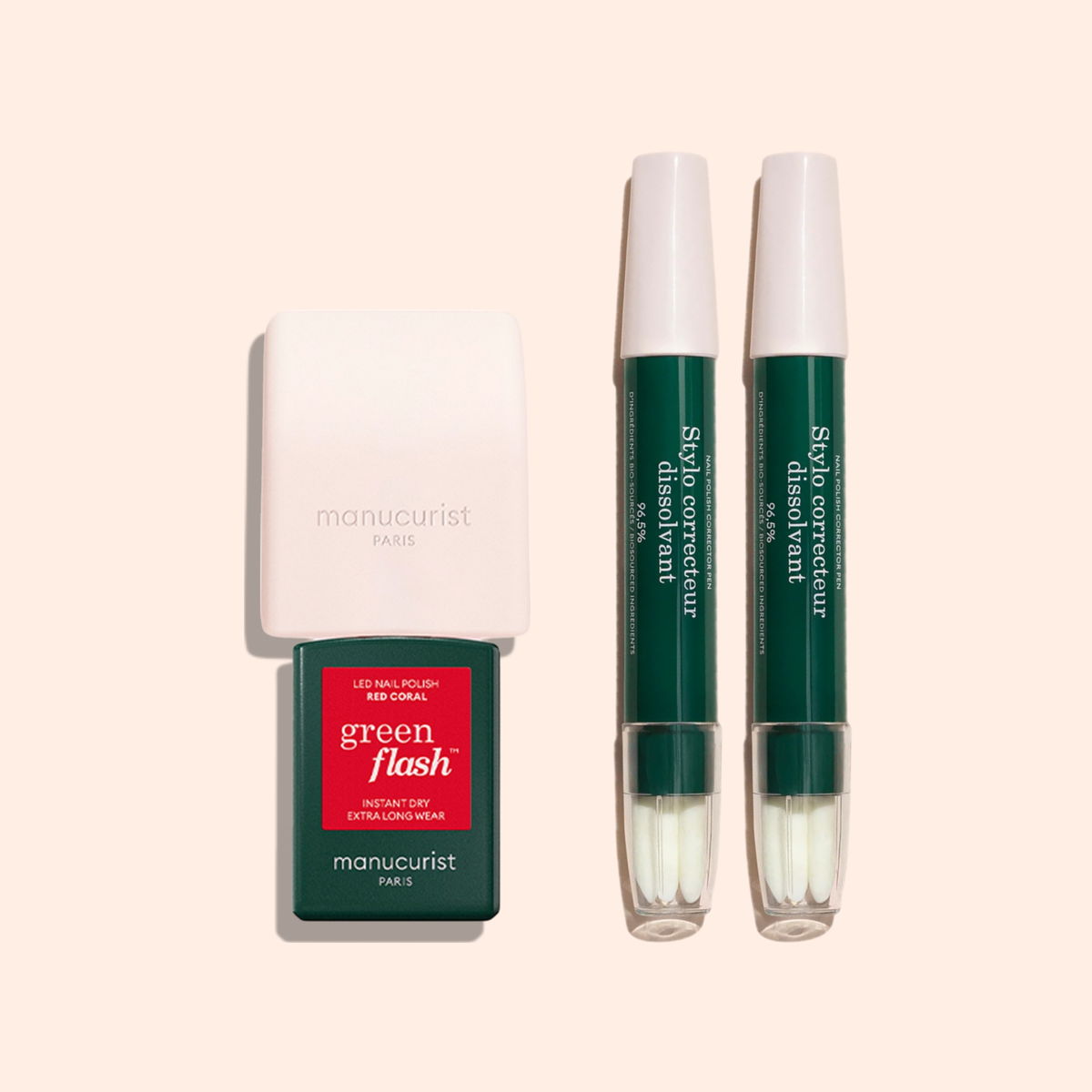 The Mani Helper by Manucurist US includes a white LED nail lamp, a green Manucurist nail polish bottle, and two green and white correcting pens, all set on a light beige background for the perfect manicure.
