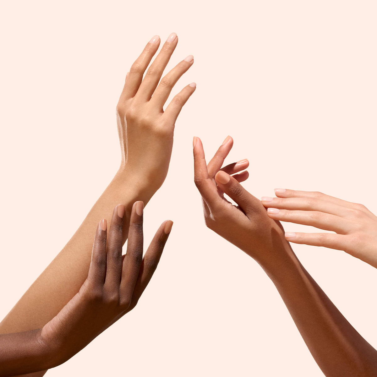 Four hands of varied skin tones display Manucurist&