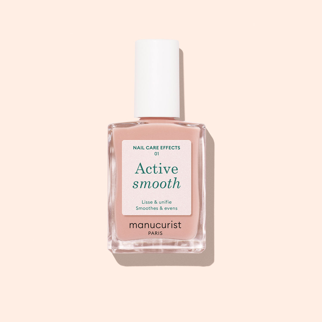 A bottle of Manucurist Active™ Smooth 01 nail care polish with a white cap is displayed against a pale peach background, showcasing this plant-based CC Polish Treatment formulated to perfect and protect your nails.