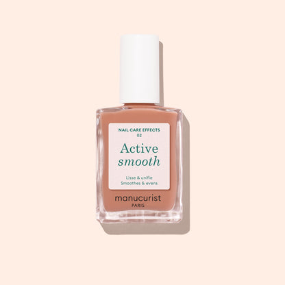 A bottle of Manucurist Active™ Smooth 02 nail care polish with a white cap, displayed against a pale peach background. The white label with green and black text emphasizes this advanced CC Polish as an ideal treatment for healthier-looking nails.