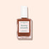 A bottle of Manucurist Active Smooth 03 nail treatment with a white cap, clear glass bottle, and beige-brown label is shown against a pale pink background.