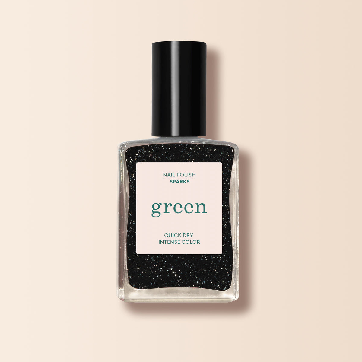 A clear glass bottle of Manucurist Sparks black nail polish with a shimmering finish and silver glitter. The label features "green" in large green text, plus "Nail Polish," "Sparks," and "Quick Dry Intense Color." Black cap included.