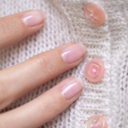 A close-up of a hand with neatly manicured nails painted in Manucurist&