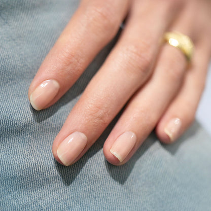A close-up of a hand with short, neatly manicured nails painted with Manucurist&