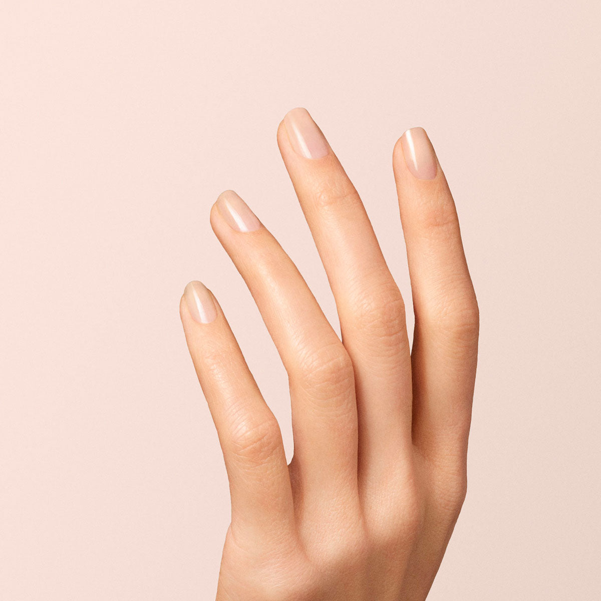 A close-up of a hand with natural, well-groomed nails painted in Manucurist&