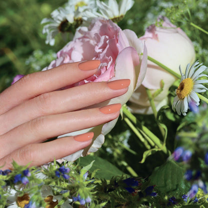 A hand with neatly manicured nails in Manucurist&