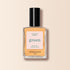 A bottle of Manucurist Abricot nail polish in a light apricot shade, featuring a black cap and set against a beige background.