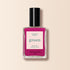 A bottle of Manucurist Armeria nail polish, a bright pinky mauve from the Green™ range, featuring intense color and quick-dry formula with a black cap, is shown against a beige background.