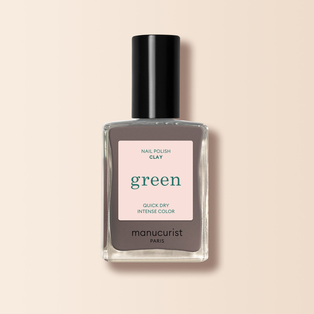 A bottle of Manucurist Clay nail polish in taupe gray, featuring a black cap and a beige label with "Nail Polish Clay, green, Quick Dry Intense Color, manucurist Paris.
