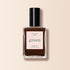 A bottle of Manucurist Clove nail polish, a chocolate brown shade from the Green™ range, features a black cap and a label reading "green, quick dry intense color" on a light beige background.