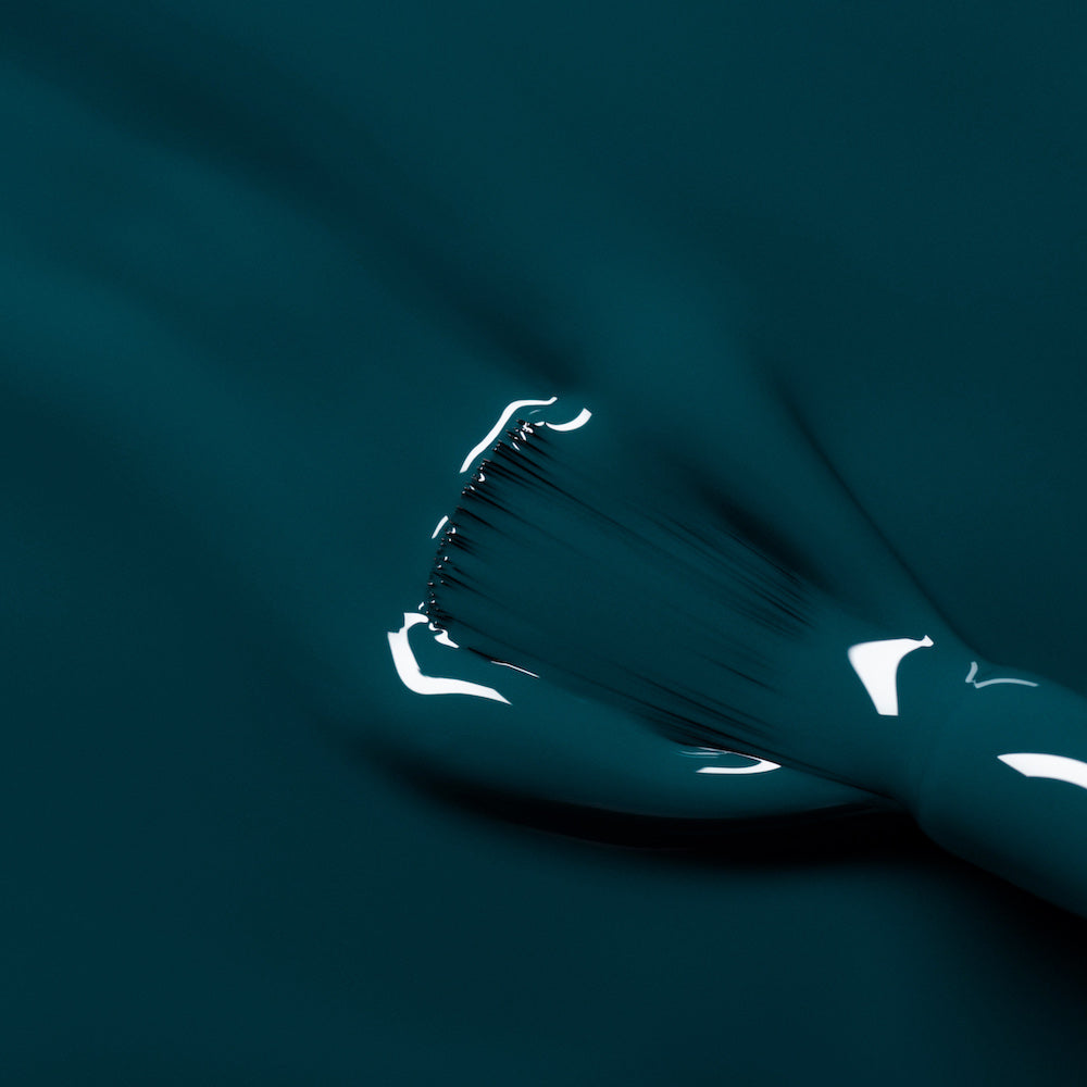 A close-up of a brush applying Manucurist&