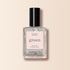 A bottle of Manucurist Diamant nail polish from the Green range, featuring a clear silver glitter shade, black cap, and pale pink label, displayed on a light beige background.