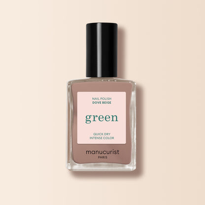 A bottle of Manucurist nail polish in the shade Dove Beige, shown in a clear rectangular bottle with a black cap and pastel beige label, set against a light beige background.