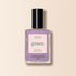 A bottle of Manucurist Lisa Lilas nail polish, featuring a black cap and lavender purple shade, from the Green™ range, set against a light beige background.