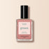 A bottle of Manucurist Old Rose nail polish, an antique powder pink shade, with a pink label featuring green and black text, set against a light beige background.
