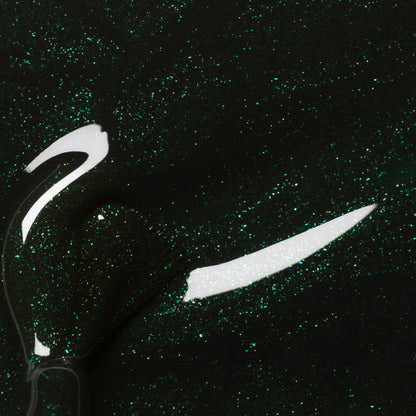 Close-up of Manucurist Poison gel polish—a forest green, glittery shade with a glossy texture, shimmering specks, and a reflective curved brush stroke on the liquid surface.