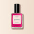 A bottle of Manucurist Pétula nail polish features vibrant pink with blue undertones from the Green range, a black cap, and a cream label with green and pink text on light beige.