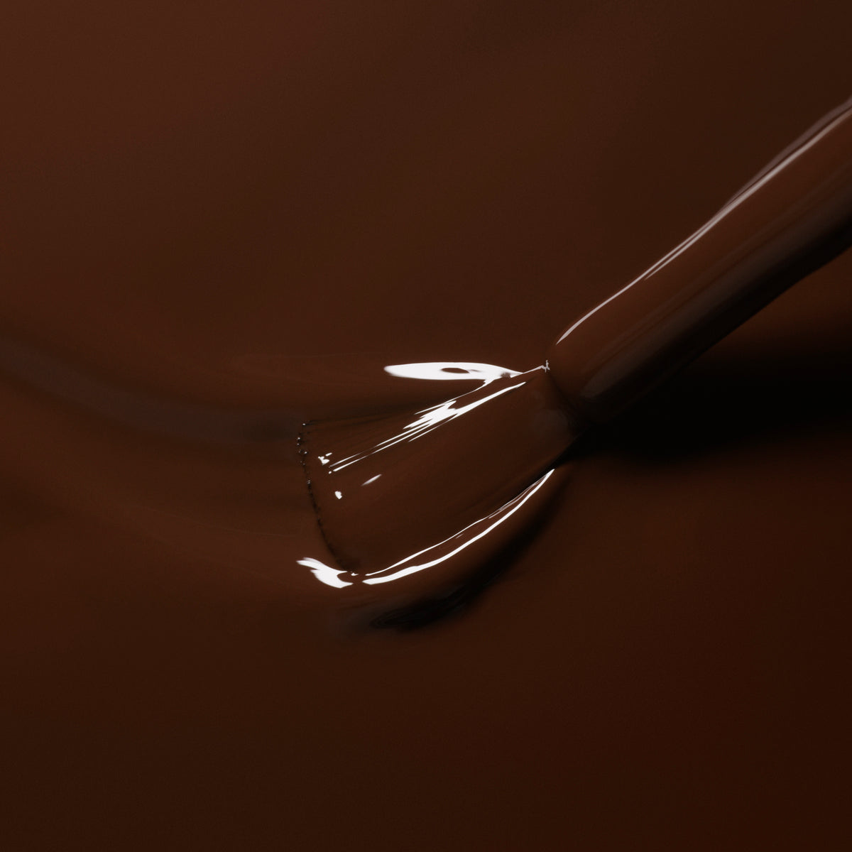 A close-up of a brush applying Manucurist&