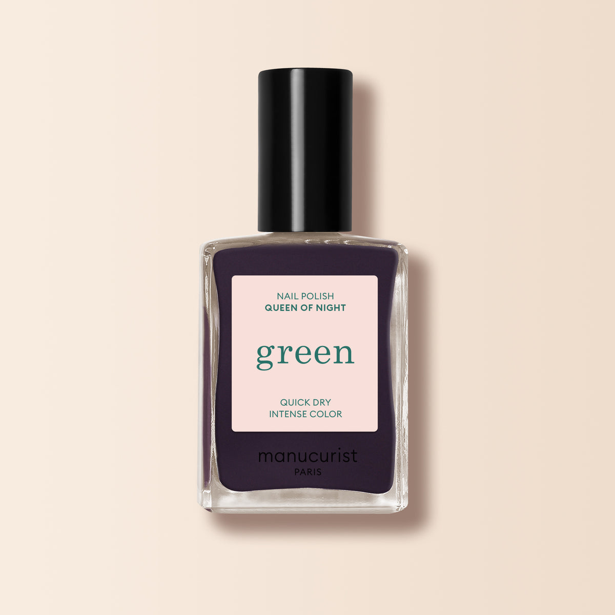 A Manucurist Queen of Night nail polish bottle, featuring a deep purple shade and black cap, is displayed against a light beige background.