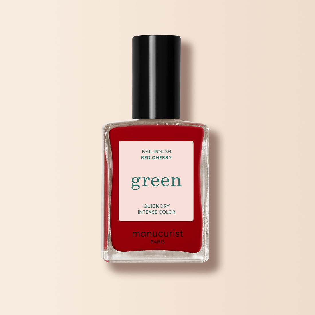 Un flacon de vernis à ongles Manucurist Red Cherry avec un bouchon noir et l&