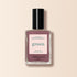 A bottle of Manucurist Rose Mountbatten nail polish, a pinky taupe shade from the Green™ range, featuring a black cap and a green label on a light beige background.