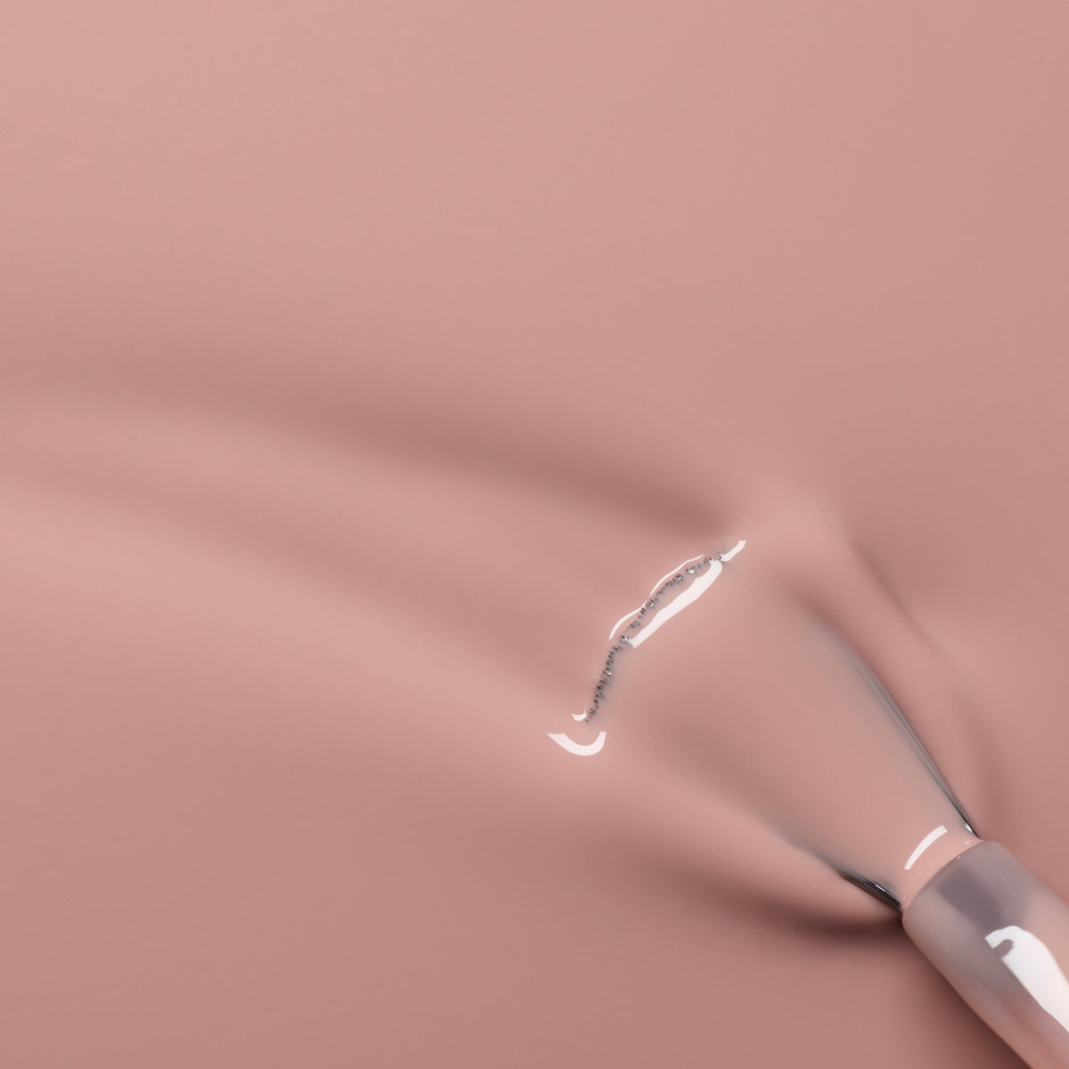 A close-up of a brush applying Manucurist&