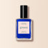 A bottle of Manucurist Ultramarine nail polish with a black cap, labeled "Nail Polish Ultramarine Green" and "Quick Dry Intense Color," from the Green™ range on a beige background.