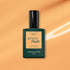 A bottle of Manucurist Abricot gel polish is shown against an orange background with a white brushstroke accent.