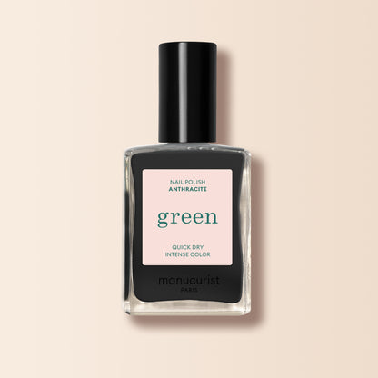 Manucurist Anthracite is a dark grey nail polish with a black cap and a label reading "green," "quick dry," and "intense color" on beige. Enjoy bold, lasting color from this eco-friendly shade.