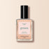 A bottle of Manucurist Beige nail polish with a black cap, labeled “green” and “quick dry intense color,” is shown against a light beige background.
