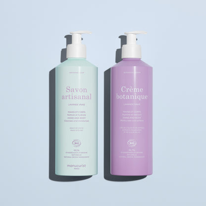 Two Manucurist products—Artisan Soap for hand and body (mint green) and Botanical Cream moisturizer (lavender)—from the Lavender Botanical Cream  Artisan Soap Duo, shown on a light blue background.