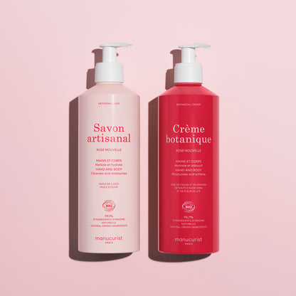 The Rose Botanical Cream  Artisan Soap Duo - Cosmos Organic by Manucurist features two pink pump bottles for hand and body care, delicately rose-scented, displayed on a light pink background.