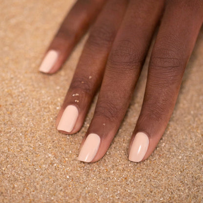 A hand with neatly manicured nails painted in Manucurist&