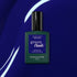 A bottle of Manucurist Navy Blue gel polish sits on a shiny deep blue surface with white curved light reflections.
