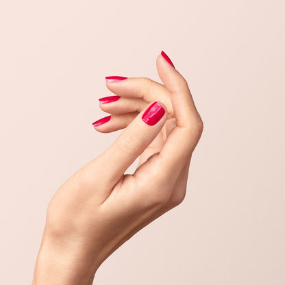 A hand with neatly manicured nails painted in Manucurist&